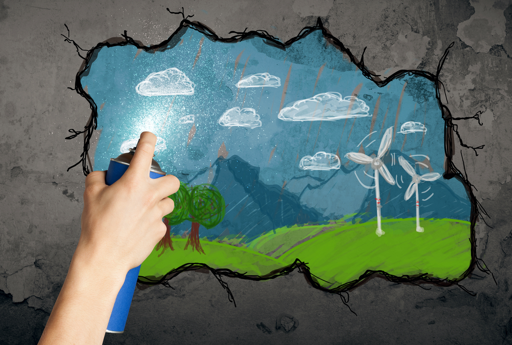 Hand zeichnet buntes Zukunftsbild an die Wand