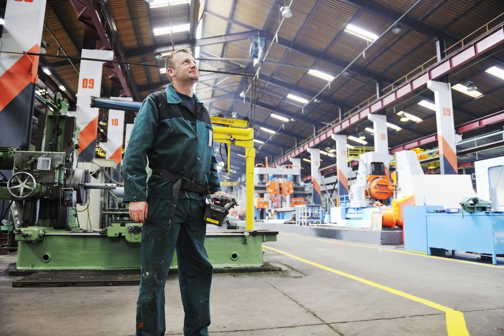 Engineer in the manufacturing industry with large, modern computers